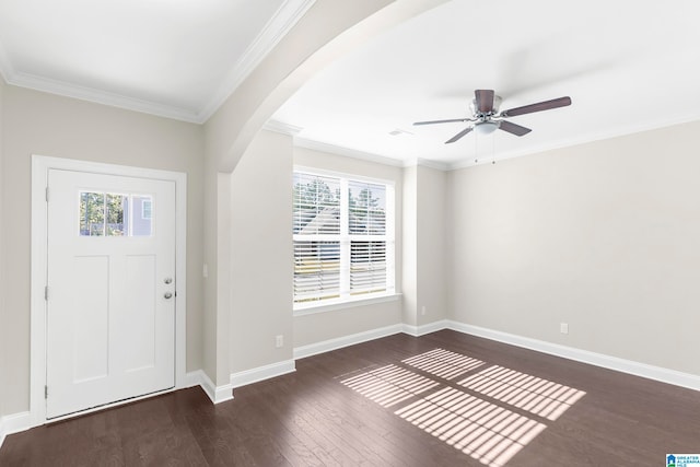 foyer with dark wood-type flooring, crown molding, and a healthy amount of sunlight