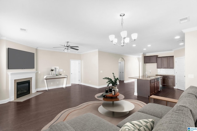 living room featuring crown molding, sink, ceiling fan with notable chandelier, and dark hardwood / wood-style flooring