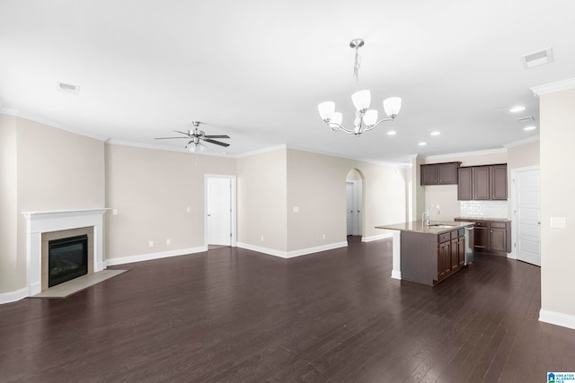 unfurnished living room with ornamental molding, sink, ceiling fan with notable chandelier, and dark hardwood / wood-style flooring