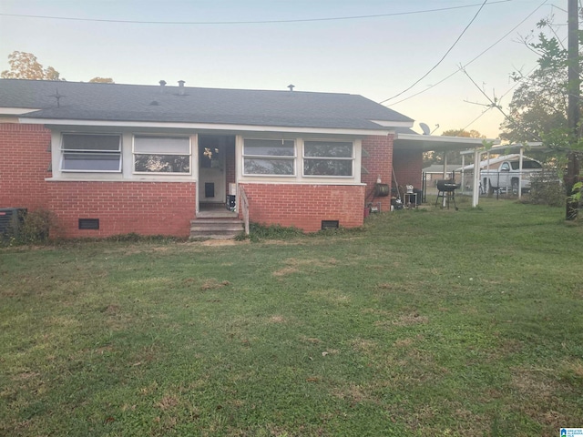 bungalow with a yard and central air condition unit