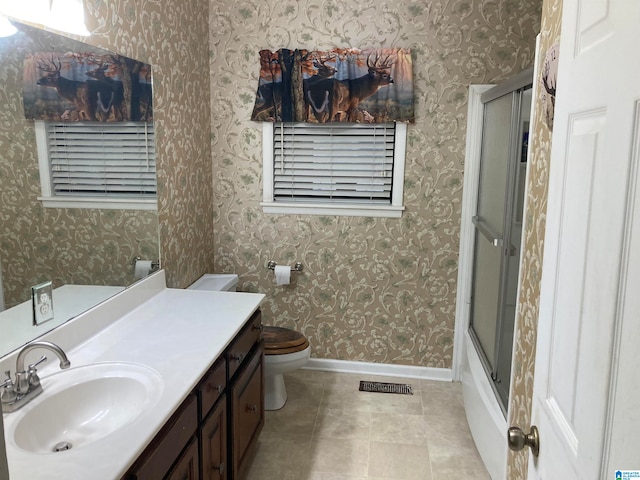 full bathroom with toilet, combined bath / shower with glass door, vanity, and tile patterned floors