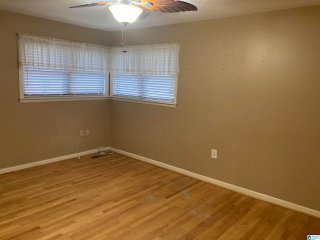 unfurnished room with hardwood / wood-style floors and ceiling fan