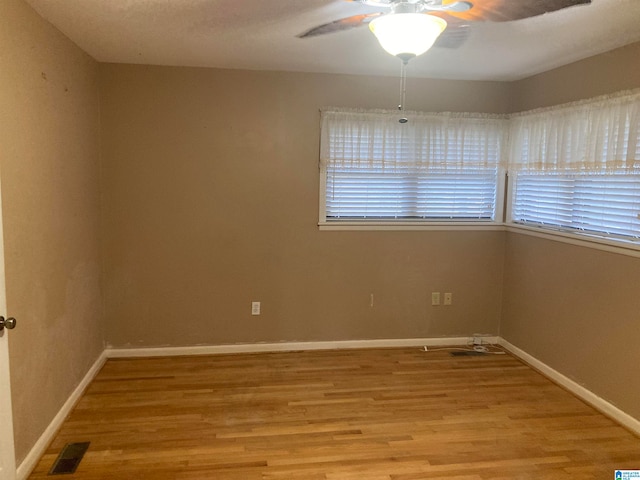 empty room featuring light wood-type flooring and ceiling fan