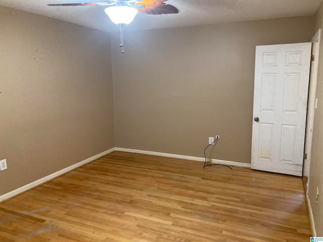 unfurnished room with light wood-type flooring and ceiling fan