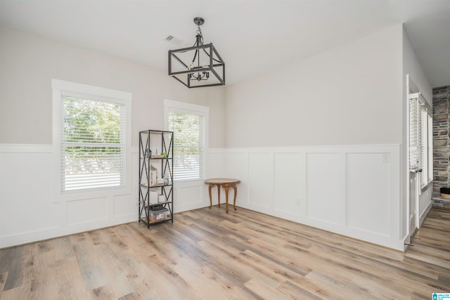 interior space with an inviting chandelier and light wood-type flooring