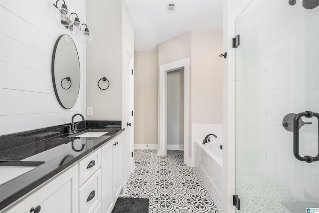 bathroom with vanity and shower with separate bathtub