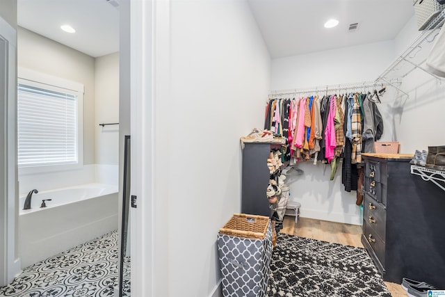 spacious closet featuring hardwood / wood-style flooring