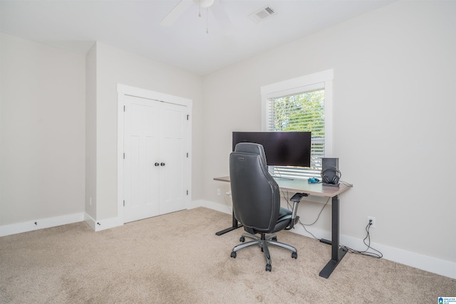 office with light carpet and ceiling fan