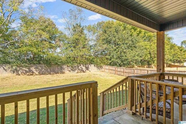 wooden deck with a lawn