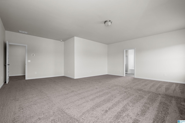 empty room featuring dark carpet