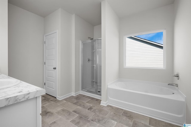 bathroom featuring vanity and independent shower and bath