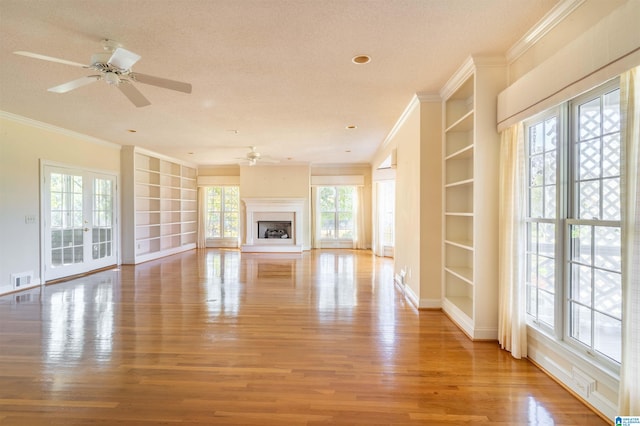 unfurnished living room with a textured ceiling, light hardwood / wood-style floors, and ceiling fan