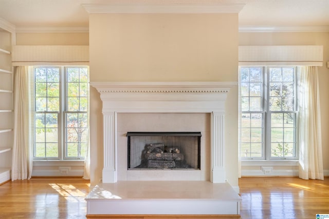 interior details with crown molding, built in features, and wood-type flooring