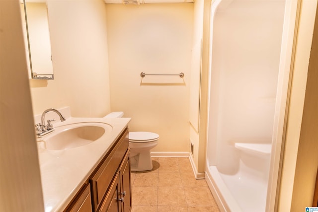 bathroom with vanity, a shower, toilet, and tile patterned floors