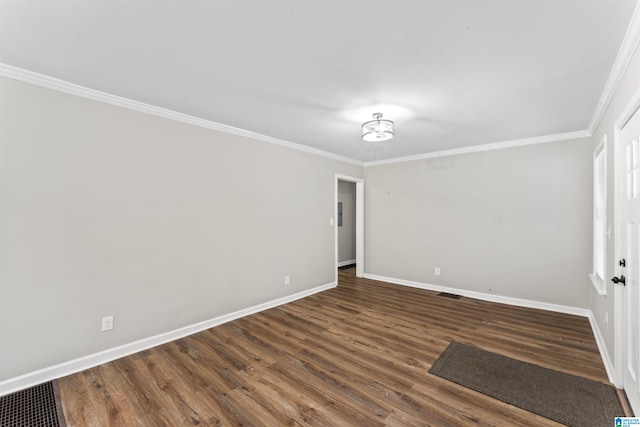 empty room with dark hardwood / wood-style floors and crown molding