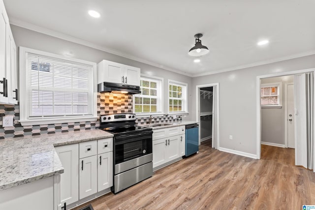 kitchen featuring stainless steel appliances, light wood-type flooring, hanging light fixtures, decorative backsplash, and white cabinets