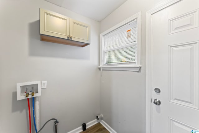 washroom featuring washer hookup and cabinets