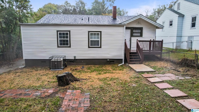 rear view of property with a deck and central AC unit