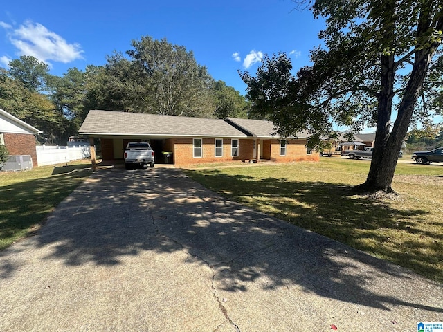 ranch-style house featuring a front lawn, central AC, and a carport