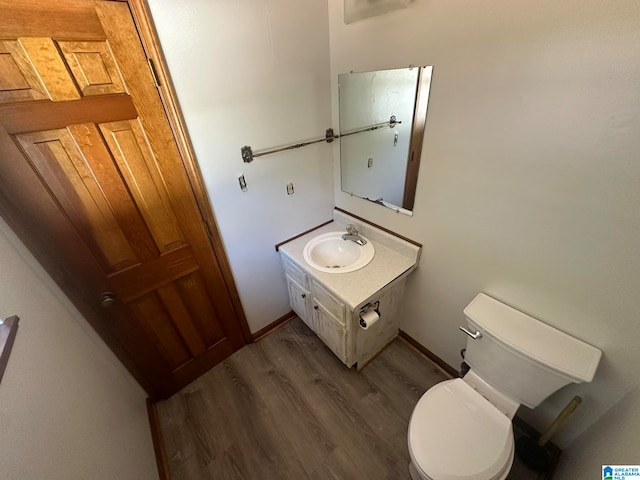 bathroom featuring hardwood / wood-style floors, vanity, and toilet