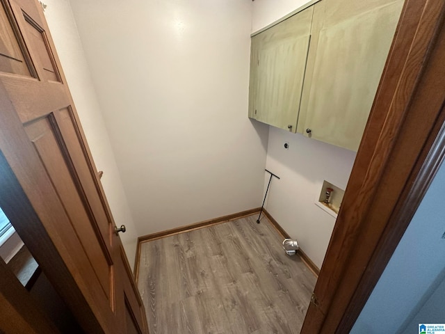 laundry room featuring cabinets, hookup for a washing machine, and light hardwood / wood-style flooring