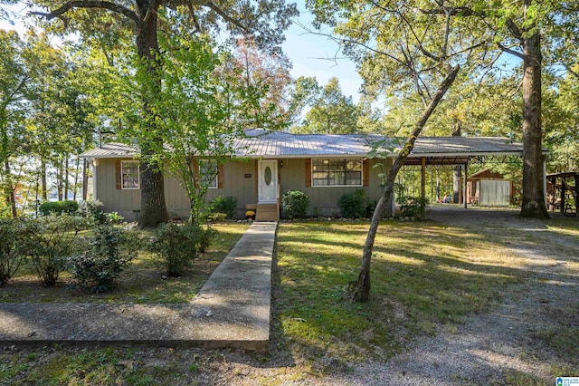 single story home with a storage unit and a front lawn