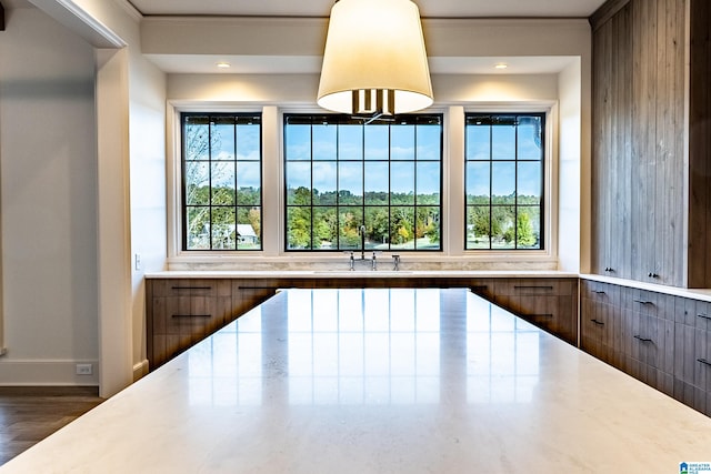 kitchen with dark hardwood / wood-style flooring, sink, and ornamental molding