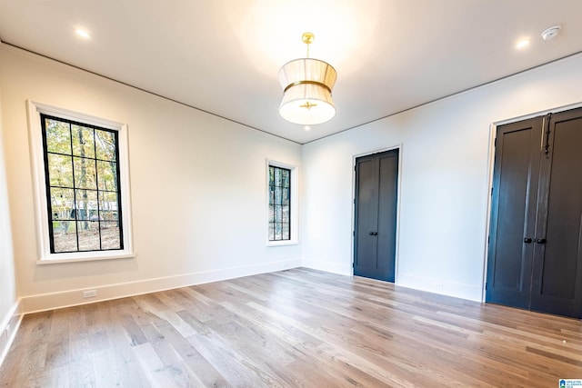 empty room with light hardwood / wood-style floors