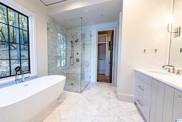 bathroom featuring ornamental molding, vanity, and separate shower and tub