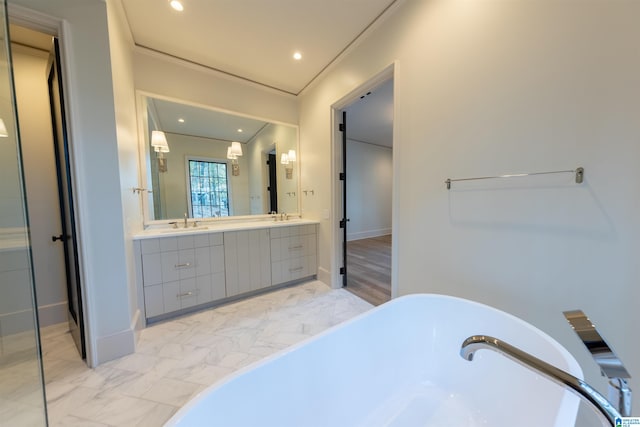 bathroom with a washtub and vanity