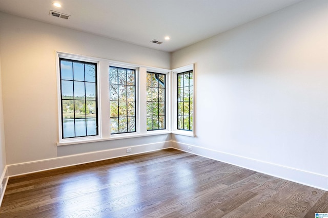 empty room with dark hardwood / wood-style floors