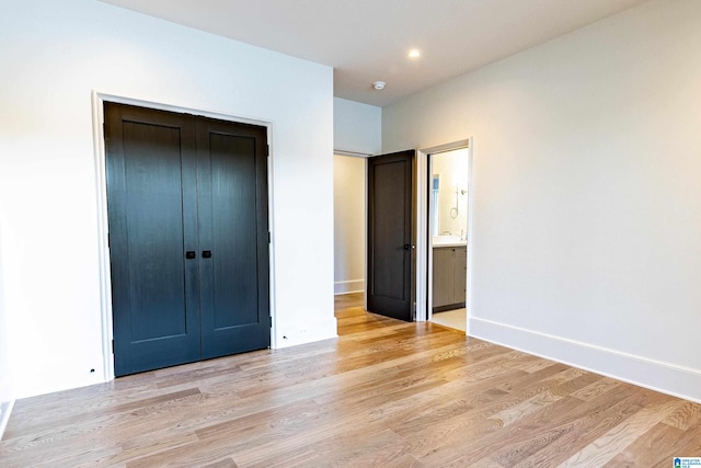 unfurnished bedroom featuring light hardwood / wood-style flooring and a closet