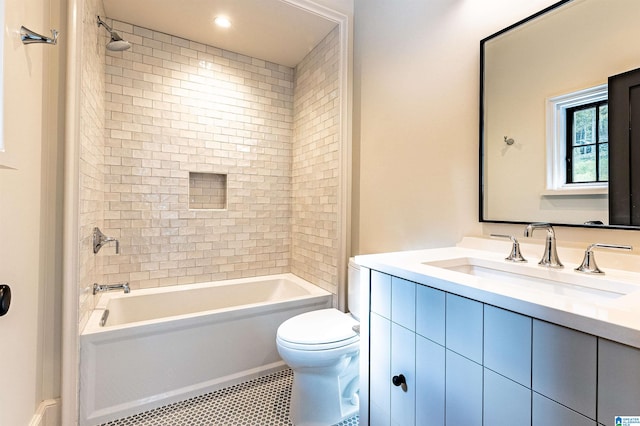 full bathroom with toilet, vanity, tiled shower / bath, and tile patterned floors