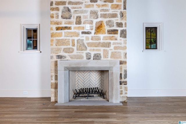 details with a fireplace and wood-type flooring