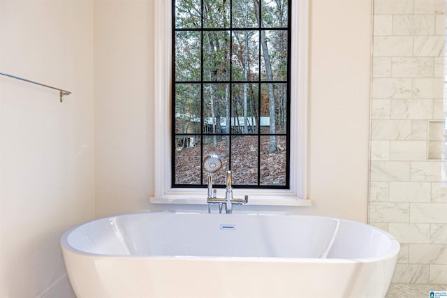 bathroom with a tub to relax in