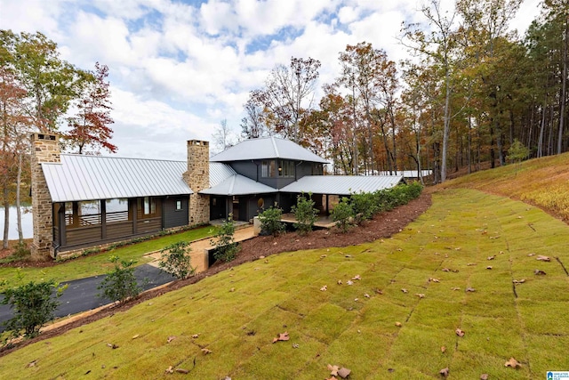 exterior space with a water view and a front yard