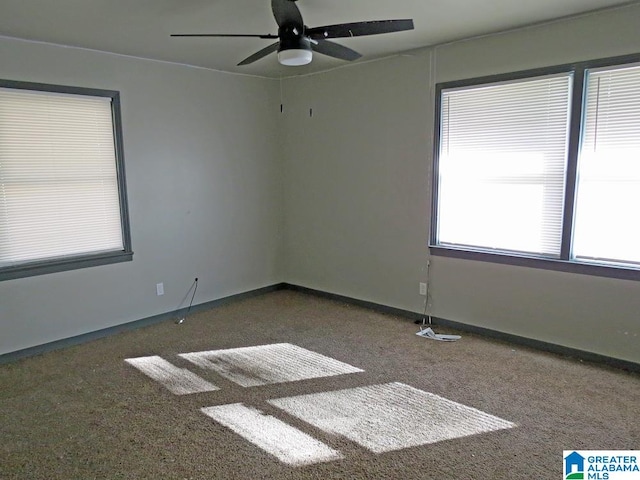 empty room featuring carpet, ceiling fan, and golf simulator