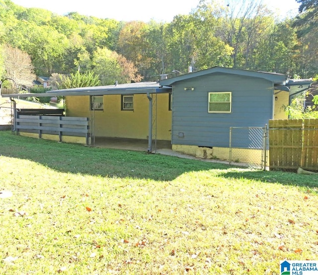 rear view of house with a yard