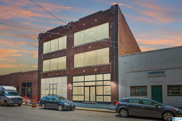 view of outdoor building at dusk