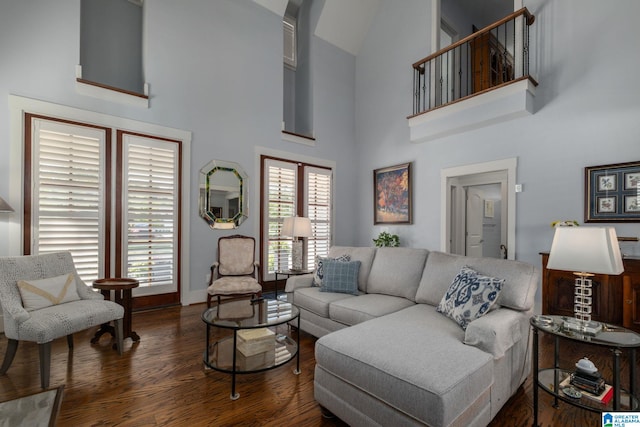 living room with dark hardwood / wood-style floors and high vaulted ceiling