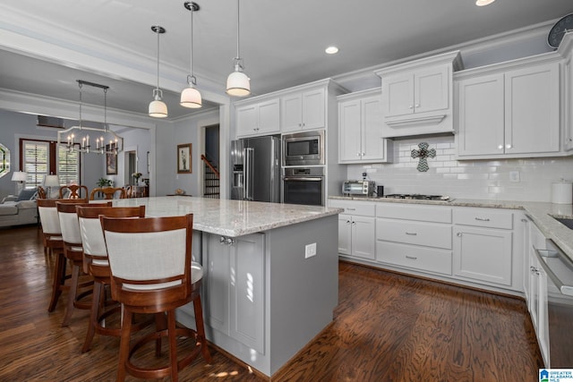 kitchen featuring a center island, stainless steel appliances, and white cabinets