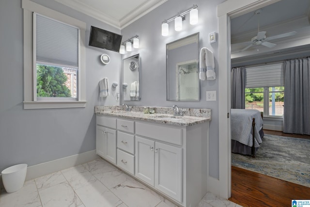 bathroom with vanity, ornamental molding, a healthy amount of sunlight, and ceiling fan