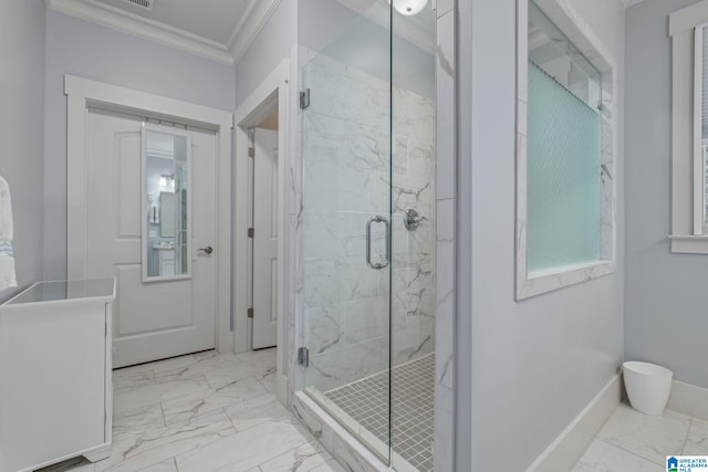 bathroom with vanity, crown molding, and a shower with shower door