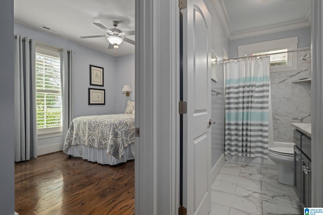 bedroom featuring ornamental molding, wood-type flooring, and ceiling fan