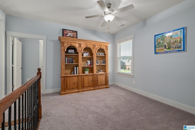 interior space featuring carpet flooring and ceiling fan