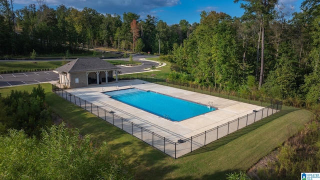 view of swimming pool with a patio area and a lawn