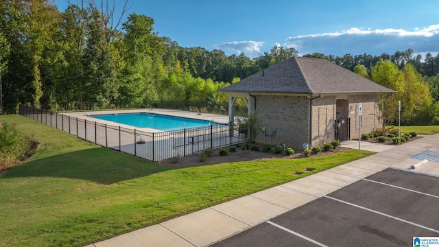 view of pool with a yard