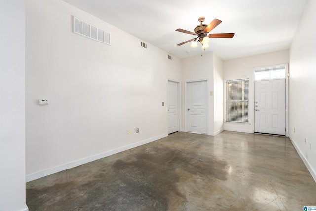 spare room with concrete floors and ceiling fan