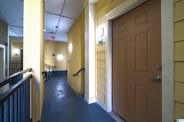 hallway with wood walls