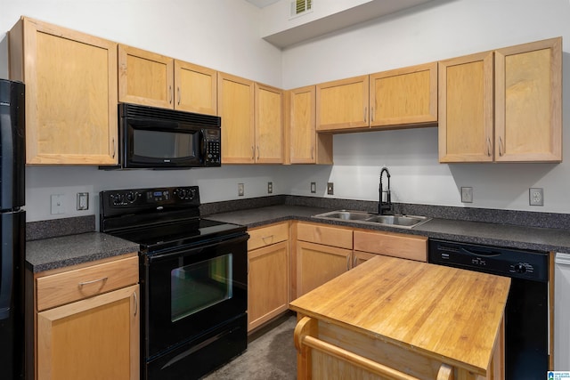 kitchen with black appliances, sink, and light brown cabinetry